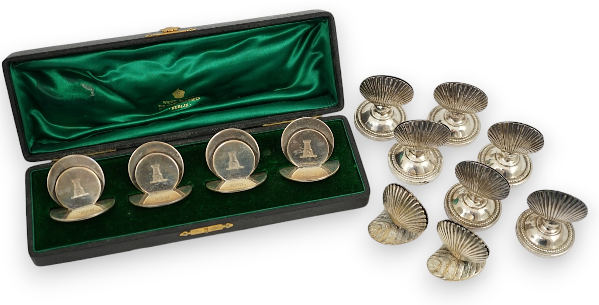 A cased set of four silver menu holders, engraved with castle crest, Sampson Mordan & Co, Chester, 1904, height 37mm, together with eight plated menu holders